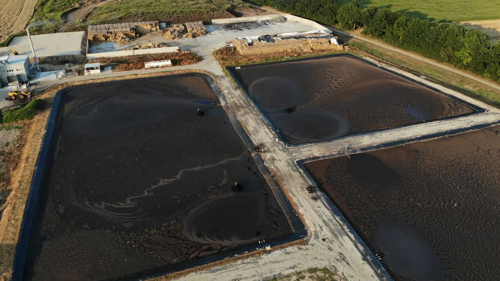 Mining operation showing water recovery process with sediment separation and clarified water being recirculated back into process pond