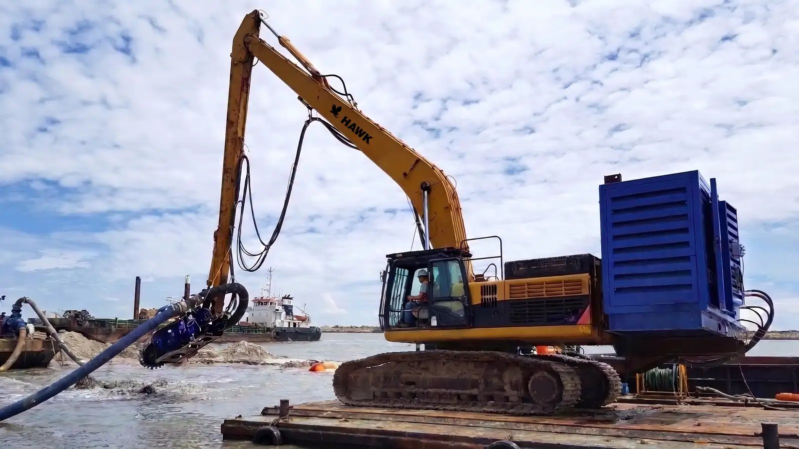 Long reach marine excavator boom extended over water, showing the reach extension options available for deeper dredging coverage.